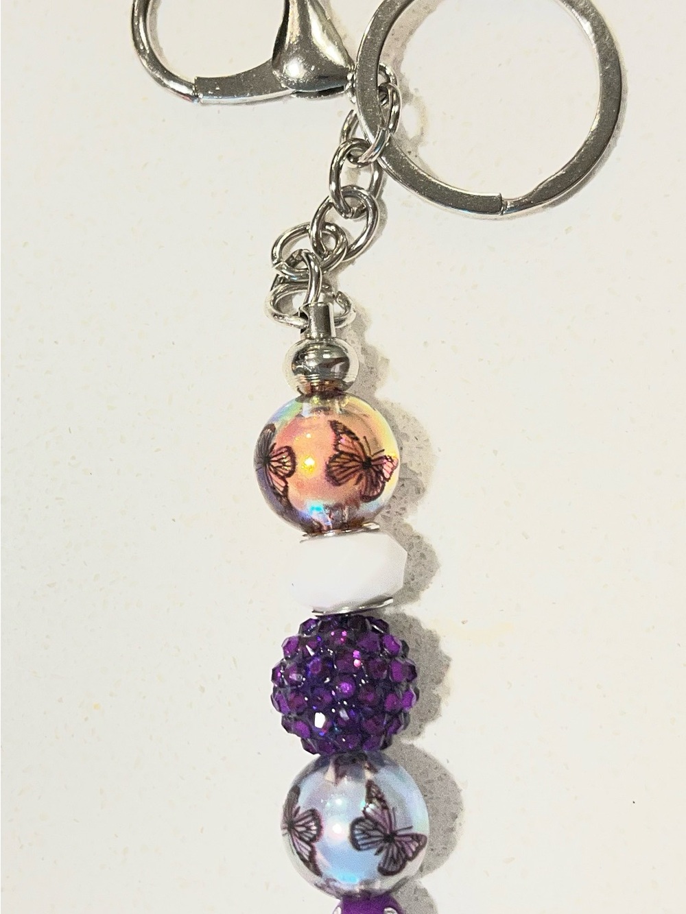 Butterfly Bead Keychain with Purple Crystal Accents.